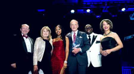 (L-R) U.S. Sen. Chris Coons, Martha Carper, DSU student Jahmyah Robertson, U.S. Sen. Tom Carper, DSU President Tony Allen, and incoming U.S. Sen. Lisa Blunt Rochester pose on stage at the Scholarship Ball after Carper was honored with Delaware State University’s inaugural UBUNTU Legacy Award. Photo submitted.